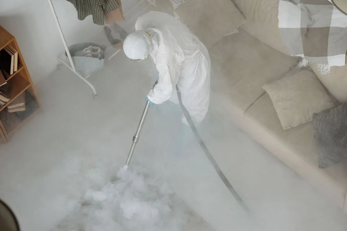 Biohazard cleanup technician in protective equipment, Belpre, OH